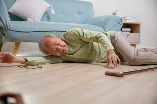 istock Asian old man lying on floor after falling down with wooden walking stick 1444323297