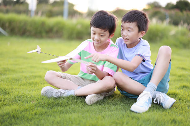istock Young boy playing with airplane toy 1444327174