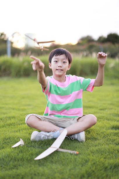 istock Young boy playing with airplane toy 1444327178