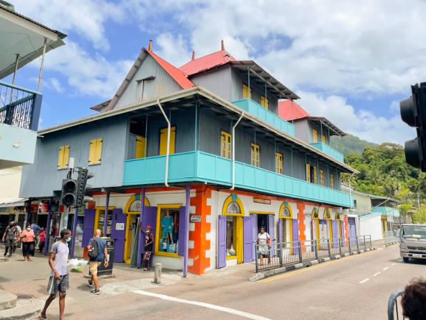 Jivan import building in town 5.10.21 Mahe Seychelles Jivan import building, the only colourful and oldest building in Victoria town, still have a colonial design and now some local stores are running their businesses inside mahe island stock pictures, royalty-free photos & images