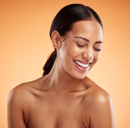istock Beauty, woman and laughing wellness, natural skincare and makeup, aesthetic cosmetics and glowing skin on orange studio background. Smile, happy and funny female model, headshot and body dermatology 1444336613