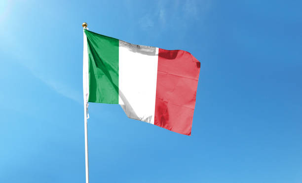 istock Italian flag in cloudy sky. Waving in the sky 1444338143