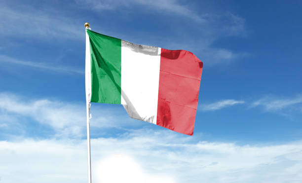 istock Italian flag in cloudy sky. Waving in the sky 1444338399