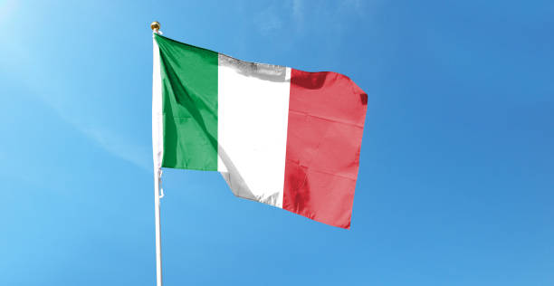 istock Italian flag in cloudy sky. Waving in the sky 1444338923