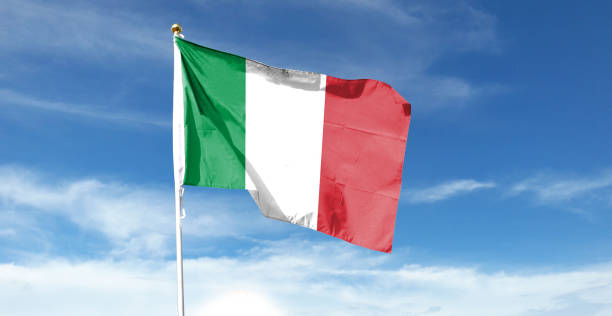 istock Italian flag in cloudy sky. Waving in the sky 1444339062