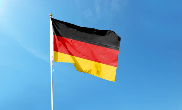 istock German flag in cloudy sky. Waving in the sky 1444340710