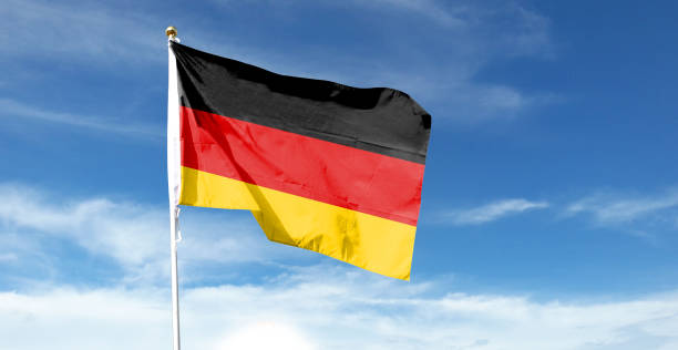 istock German flag in cloudy sky. Waving in the sky 1444340812