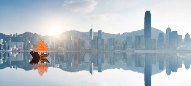 istock Red junk boat crossing Hong Kong harbor 1444348653