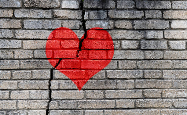 istock Red heart on a cracked wall 1444349631