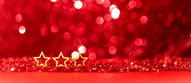 Three christmas stars on shiny red background