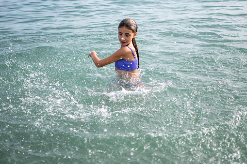 Happy little girl enjoying to sea