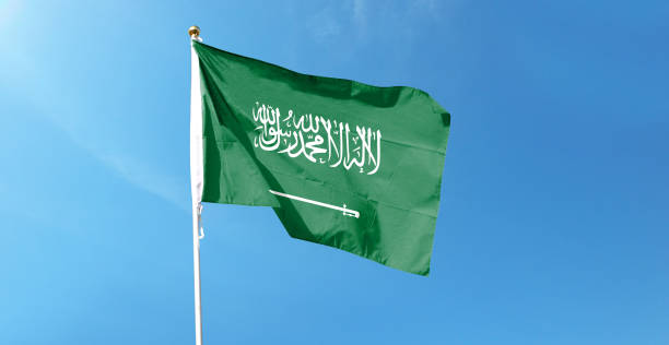 istock Saudi Arabian flag in cloudy sky. Waving in the sky 1444351571