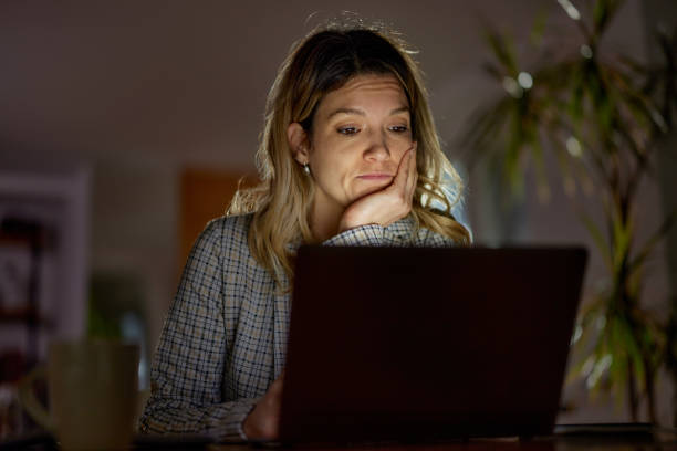 istock Young businesswoman working on computer late in home office. 1444352284