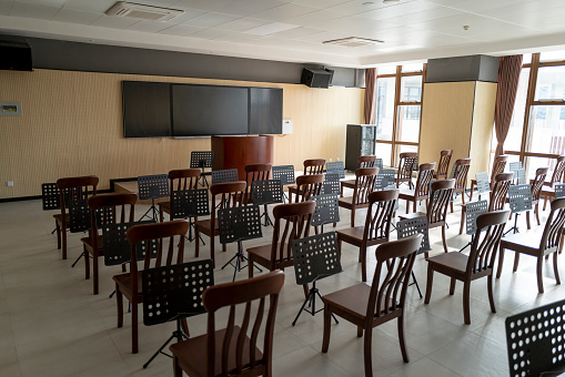 Elderly university music classroom, rows of tables and chairs