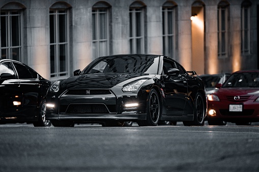 Calgary, Canada – June 02, 2022: A black Nissan Skyline GTR stopped at a red light in traffic