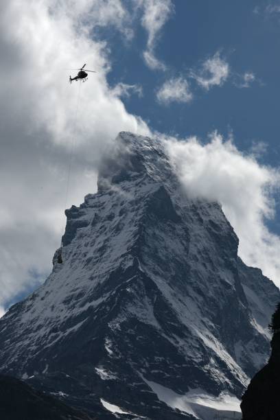 istock Matterhorn with cloud and helicopter passing by insight 1444356987