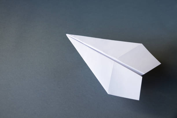 istock White paper plane origami isolated on a grey background 1444360713