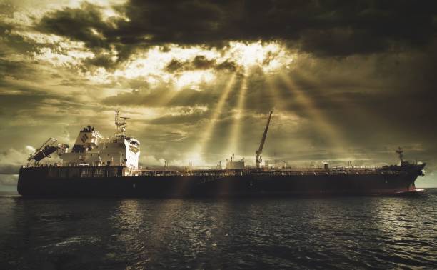 istock Vessel in the sea on a cloudy day under sunbeams 1444361100