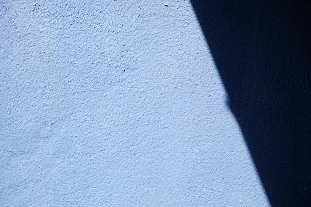 istock Sunlight Beam on Blue Paint Concrete Wall Background. 1444361269