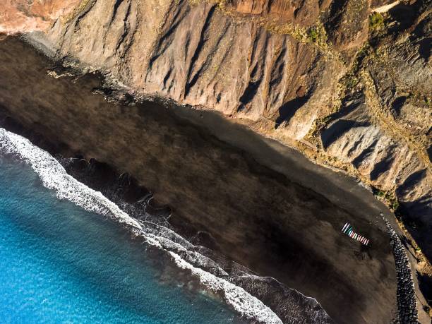 istock Aerial shot over black sandy beach 1444361474