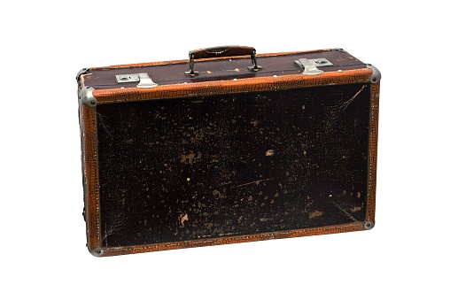 A closeup shot of an old leather suitcase isolated on white background