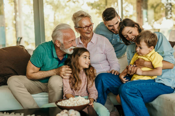 Family popcorn and sofa time stock photo