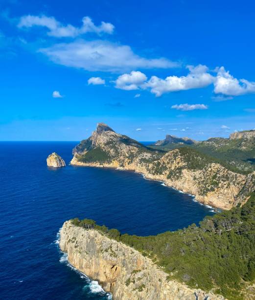 istock Beautiful view of greenery mountains surrounded by water under blue bright sky 1444362704