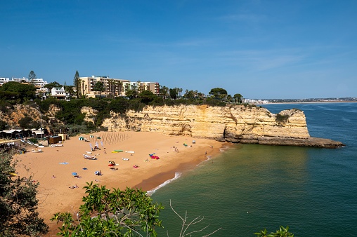 A beautiful view of a sandy beach on a sunny day in Porches, Algarve, Portugal