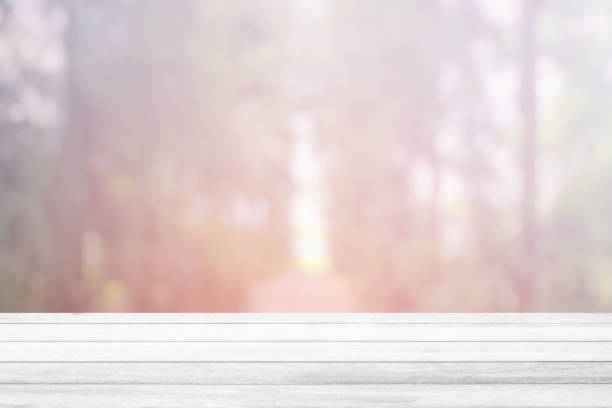 istock White Wood Table with Blurred Christmas Tree Park Background, Suitable for Product Display. 1444364807