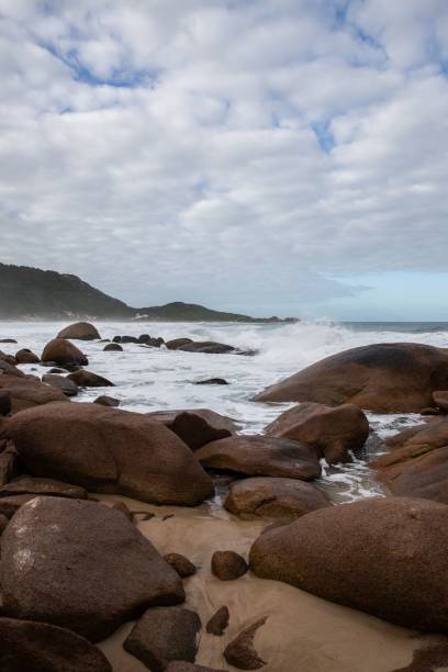 istock Huge waves hitting the rocks on the seashore 1444364956