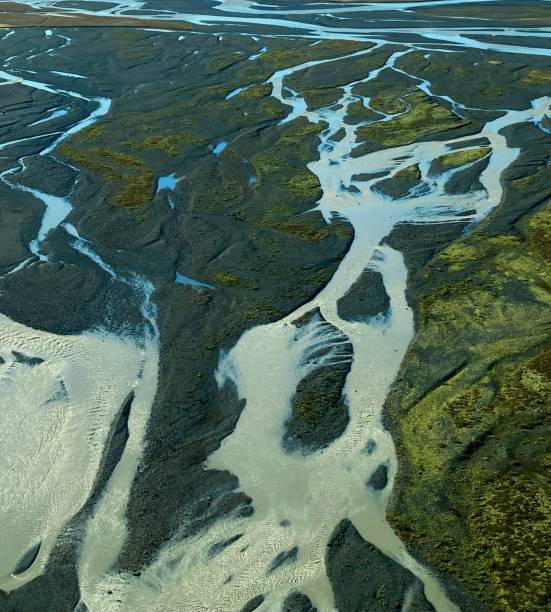 istock Aerial view of a large river flowing through a plain and a forest at daytime 1444365644