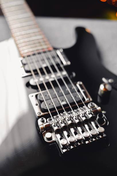 istock Closeup shot of black guitar 1444366874