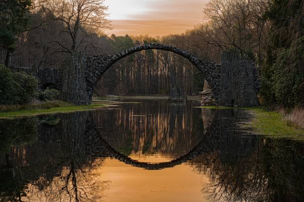 istock Scenic view of the Devil's Bridge reflecting on a lake in a forest in Gablenz, Germany 1444367009