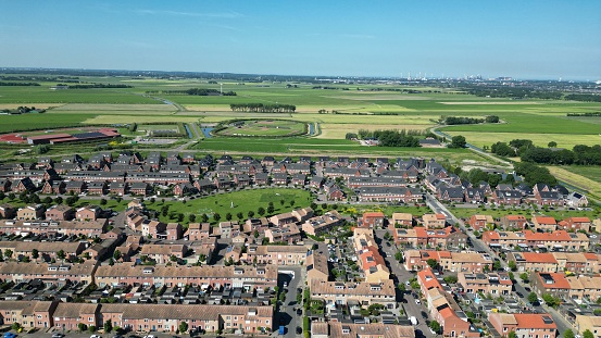 A drone shot of the Assendelft town with traditional houses and treees in The Netherlands