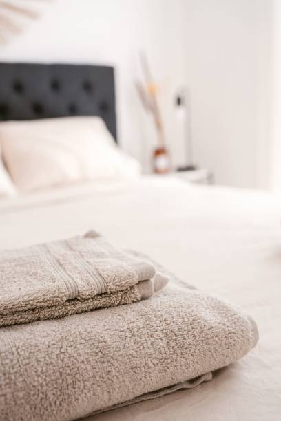 istock Closeup of towels on bed in minimalistic setting 1444373422