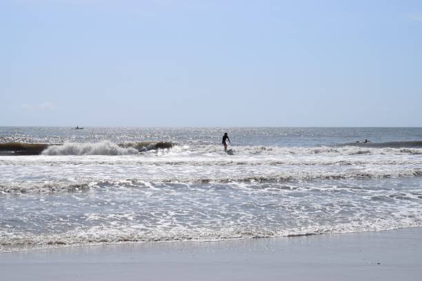 istock Big waves hitting the seashore with a cloudy blue sky 1444373479