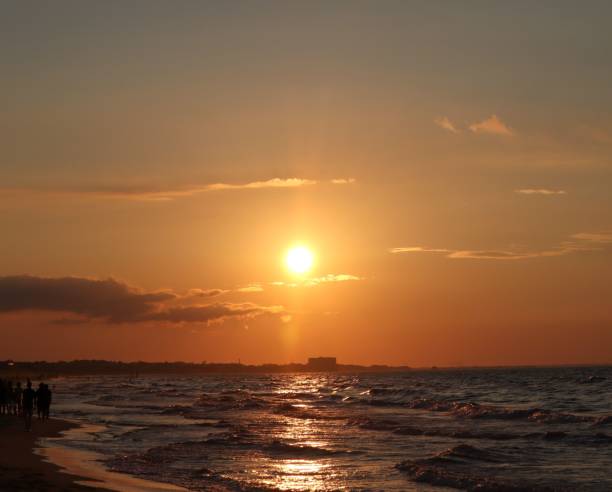 istock Shining golden, orange sunset reflected on surface of undulating Atlantic Ocean on summer evening 1444374257