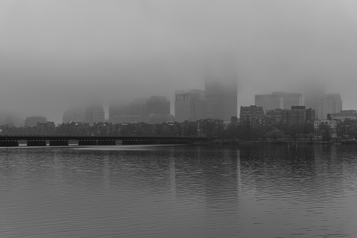 A grayscale shot of the Boston skyline in the fog. Massachusetts, United States.