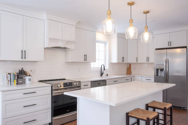 istock Modern white kitchen interior with an oven, sink, faucet, a wooden cabinet, and table 1444379607