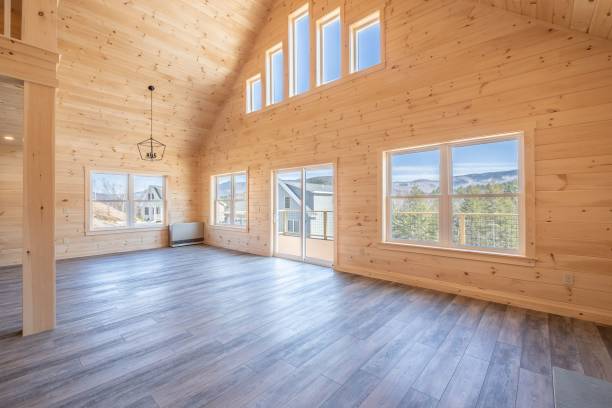 istock Empty room interior with wooden walls, windows, and a laminate floor 1444379653