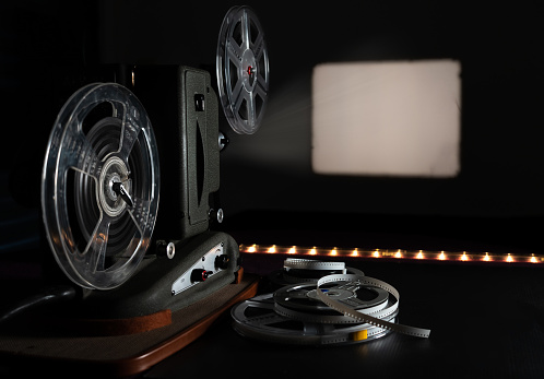 Film reels on black background. Movie, video and cinema prodaction and edition concept. 3d illustration