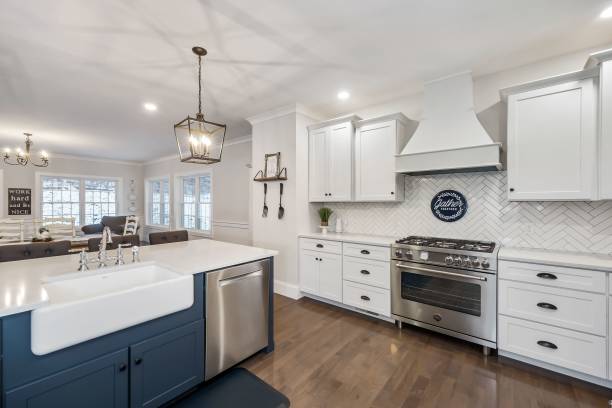 istock Contemporary kitchen with white cabinetry and island sink 1444380013