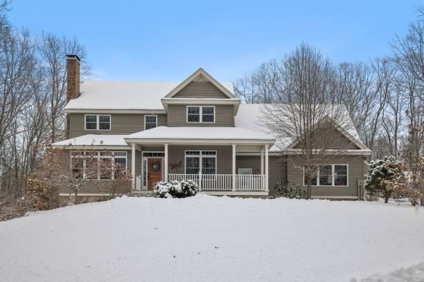 istock Snow-covered field outside a country house during winter 1444380270