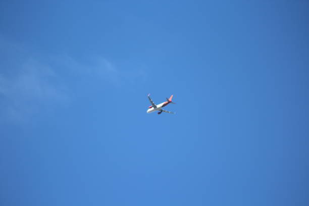 istock Airplane flying in blue sky. 1444381359