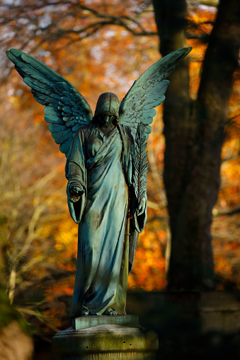 Old copper angel statue in a cemetery