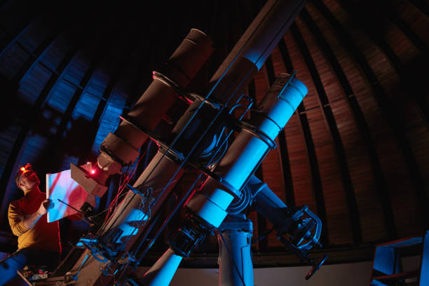 istock Astronomer with a big astronomical telescope in observatory doing science research of space and celestial objects. 1444384004
