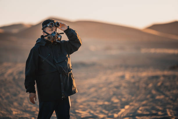 istock Asian Chinese man with  steampunk mask in Sahara Desert 1444384102