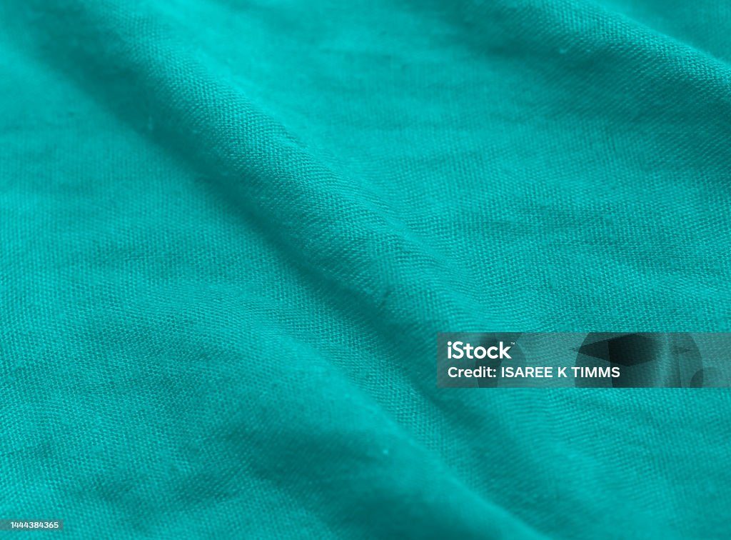 Green fabric crumble  textures background. abstract green crumpled of cotton and fabric cloth wavy grunge cotton texture synthetic fiber background. Crepe - Textile Stock Photo