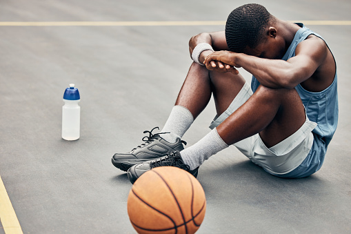 Tired, depression or sad basketball player with training gear after game fail, mistake or problem. Depressed, mental health and anxiety or stress sports, athlete teenager man frustrated with results