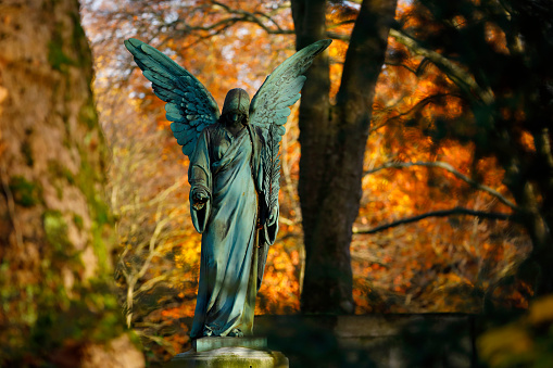 Old copper angel statue in a cemetery